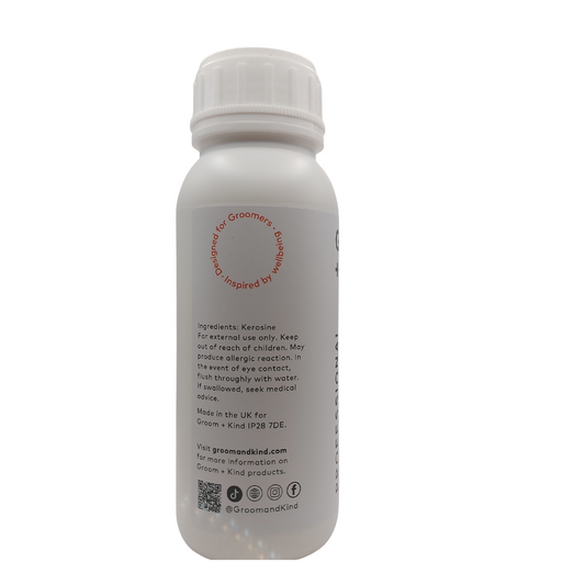 White bottle of blade wash with text on a white background.