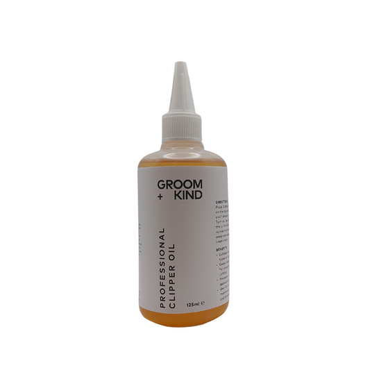 125ml bottle of Groom + Kind professional clipper oil on a white background.