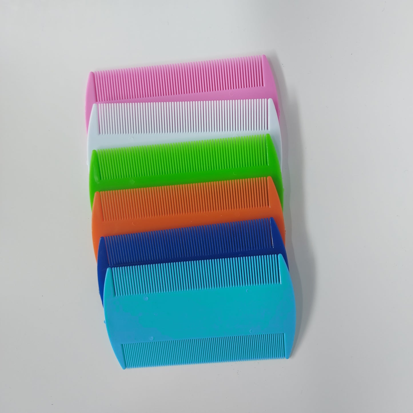 Assortment of flea combs in various colors.