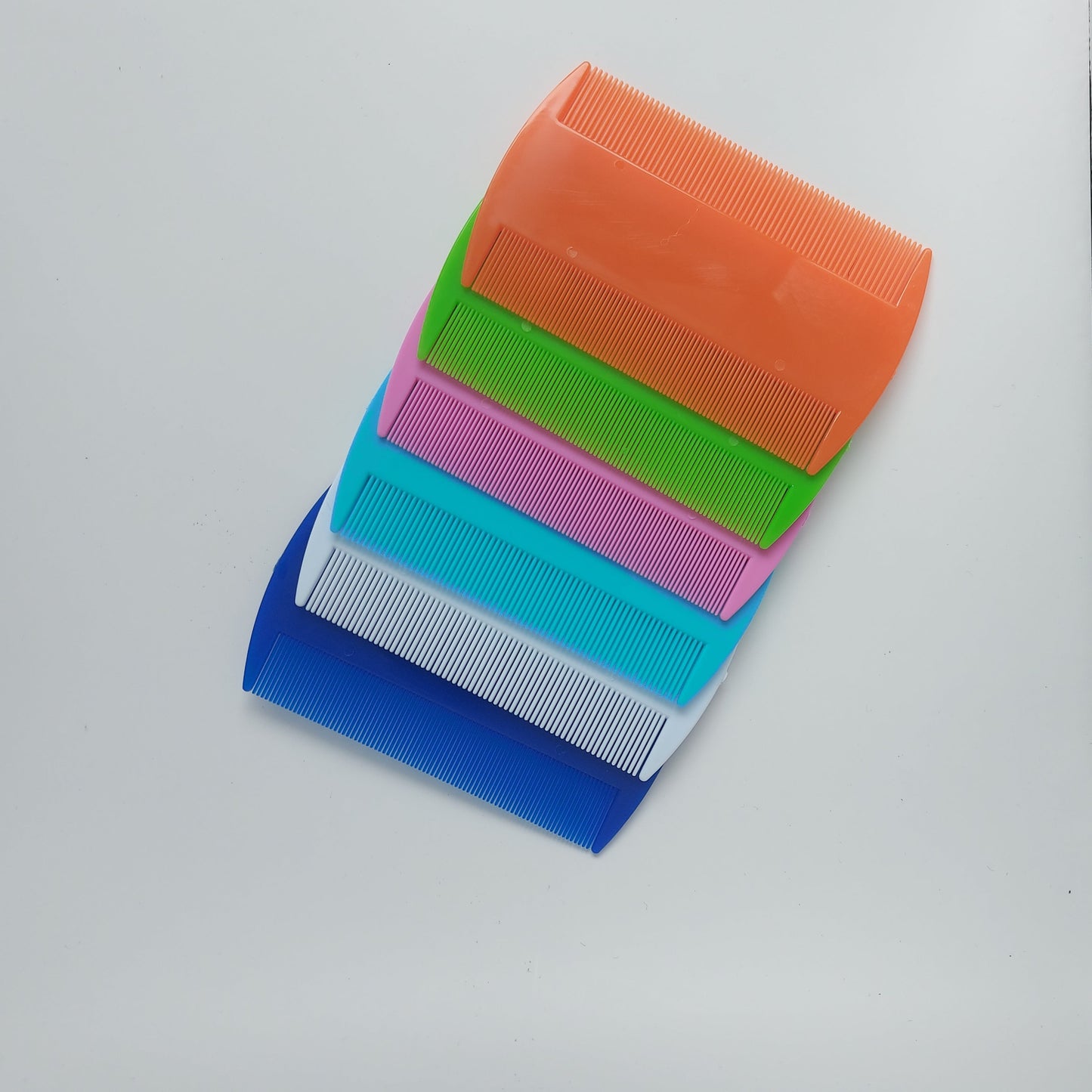 Packaged flea combs for pets, designed to remove fleas and debris from fur.