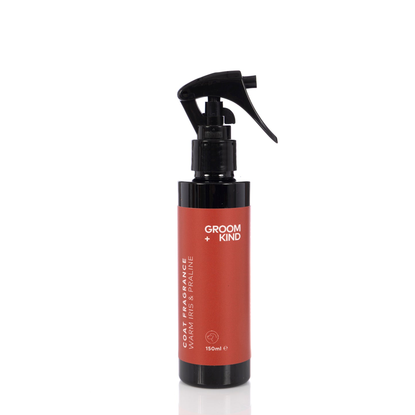 Red spray bottle of Groom + Kind coat fragrance with black nozzle on a white background