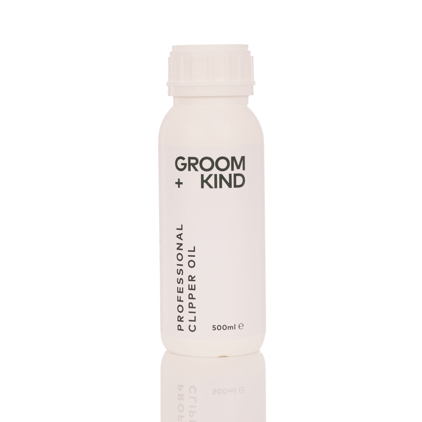 500ml bottle of Groom + Kind professional clipper oil on a white background