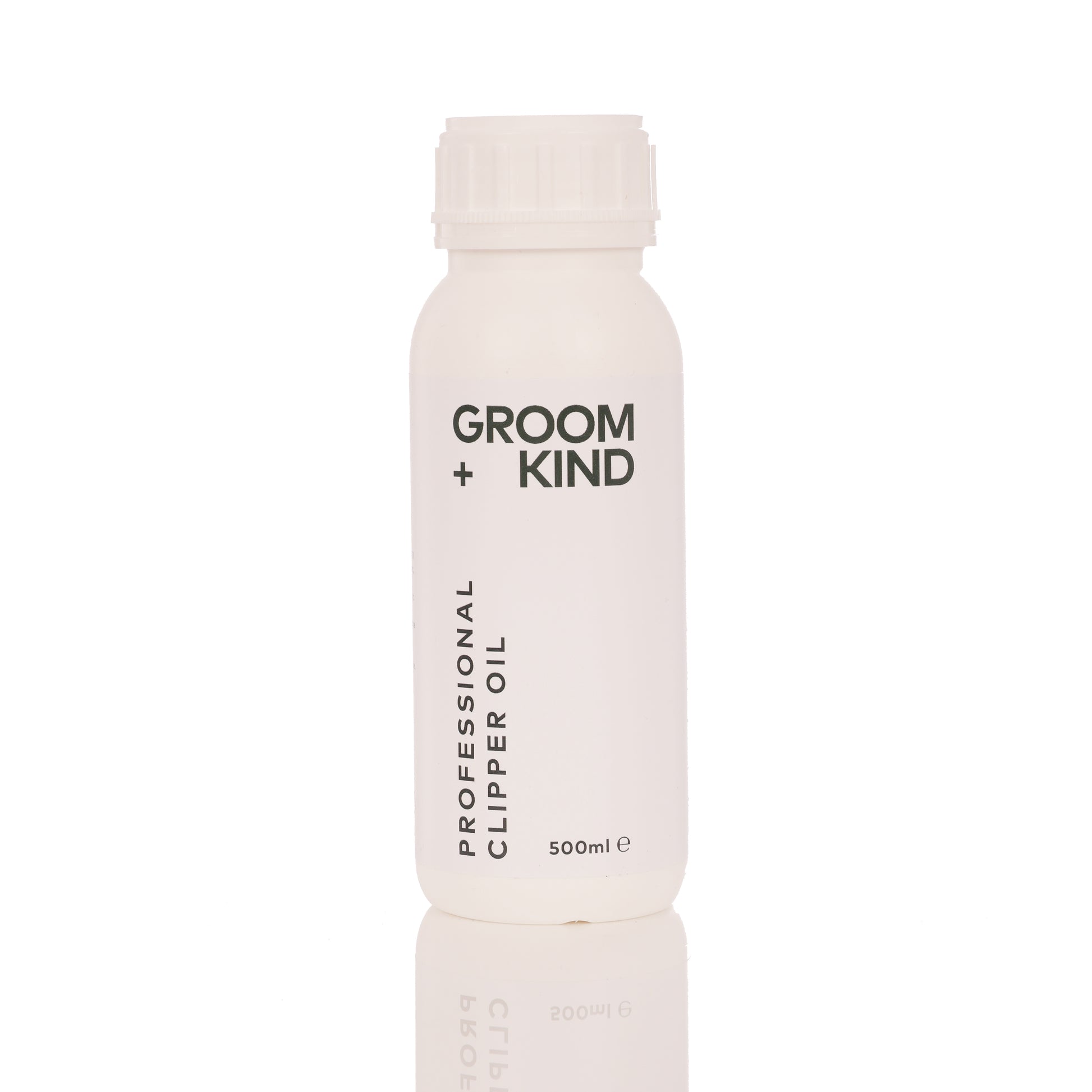 500ml bottle of Groom + Kind professional clipper oil on a white background
