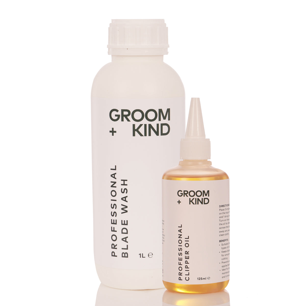 Two bottles of Groom + Kind Blade Wash and Clipper Oil on a white background
