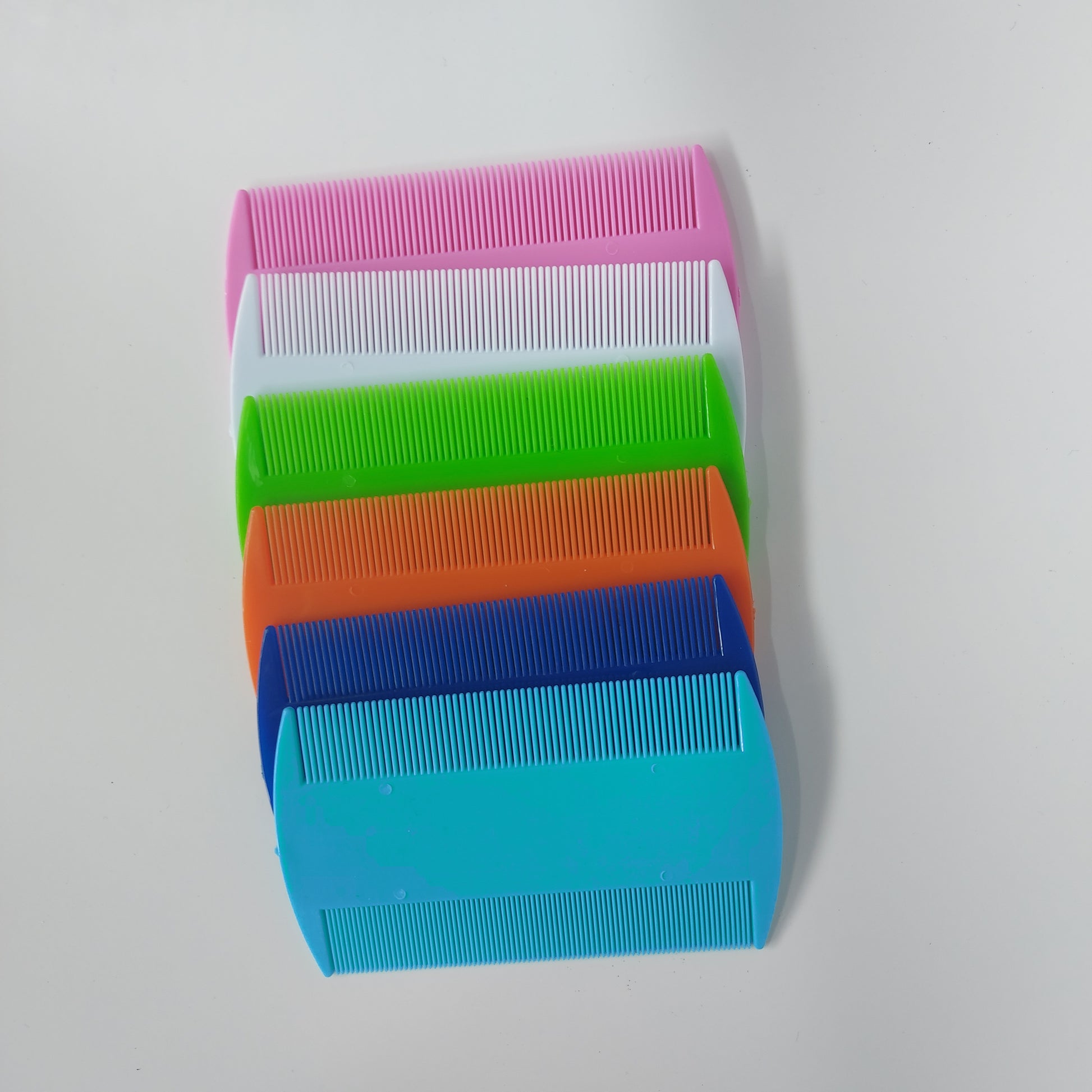 Assortment of flea combs in various colors.