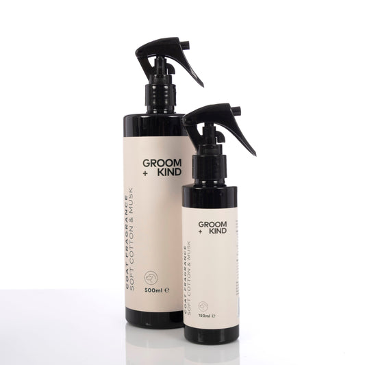 Two bottles of Groom + Kind Dog Cologne products on a white background