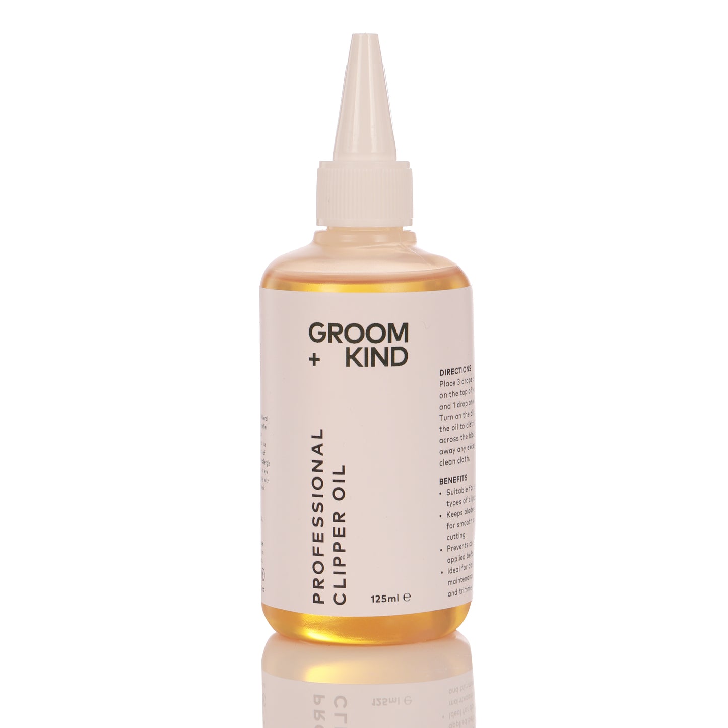 125ml bottle of Groom + Kind professional clipper oil on a white background